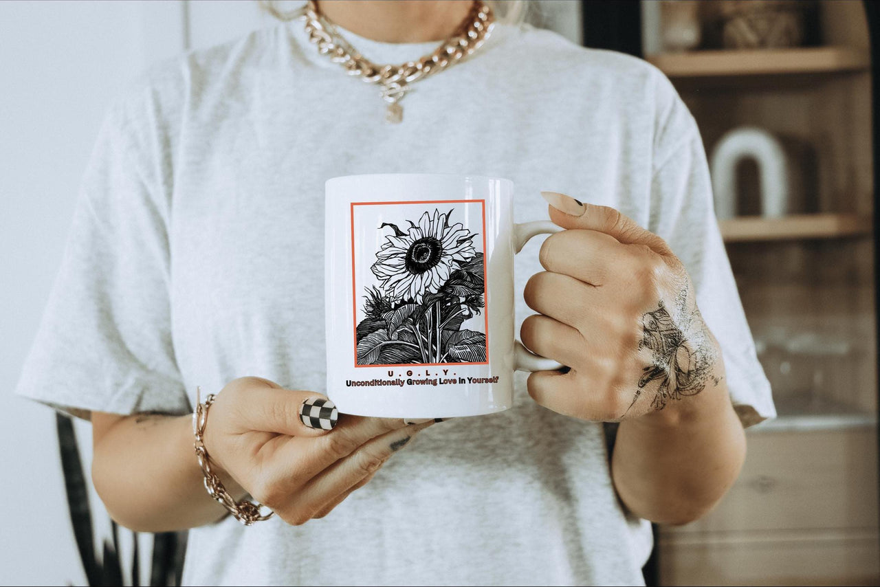 a woman holding a coffee mug with a tarot card on it
