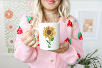 Thumbnail for a woman holding a coffee mug with a sunflower on it
