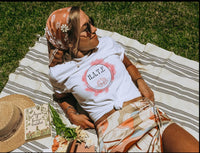 Thumbnail for a woman laying on top of a blanket next to a hat