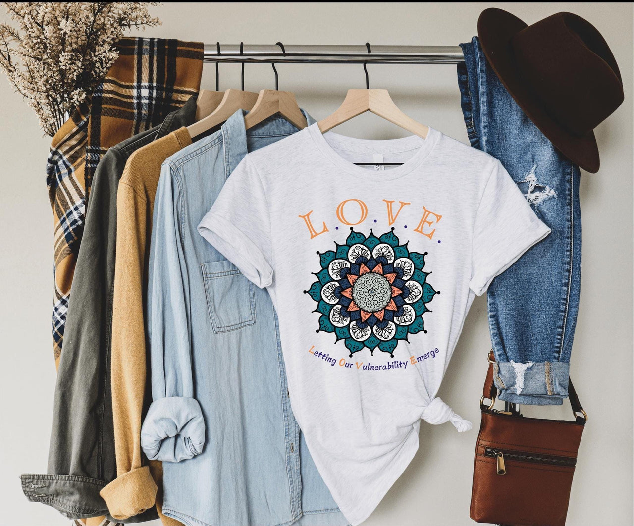 a t - shirt and jeans hanging on a rack