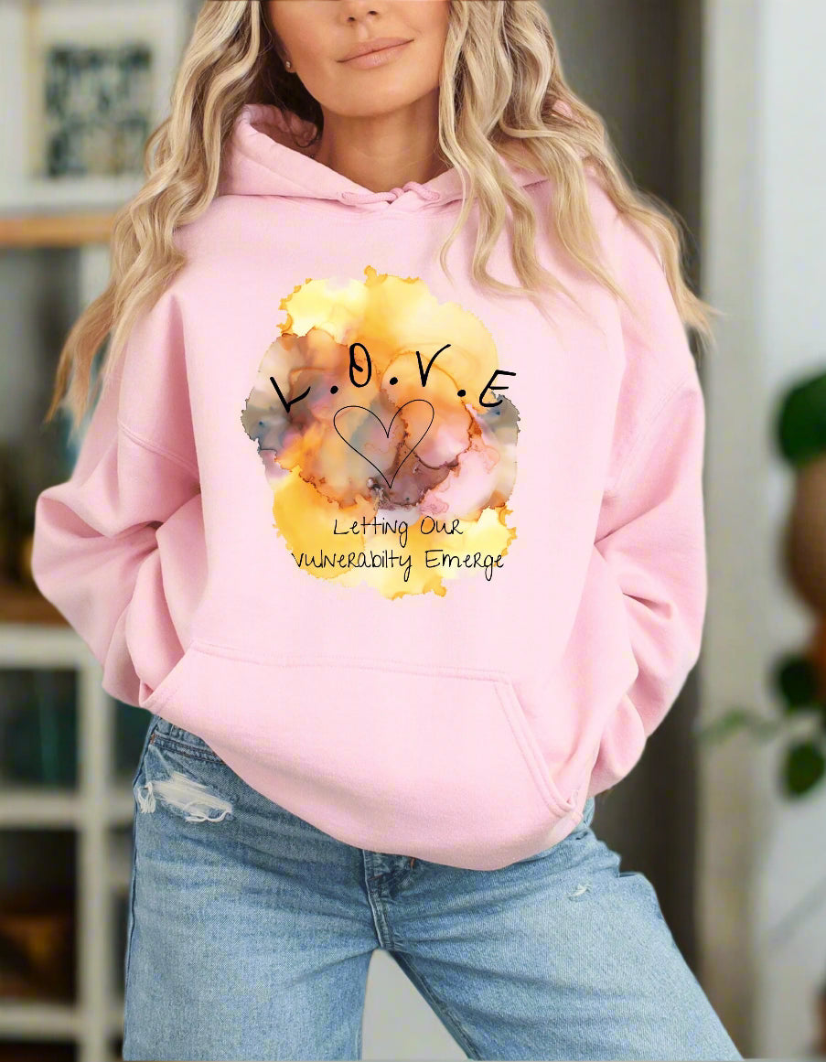 a woman wearing a pink hoodie with the words love on it