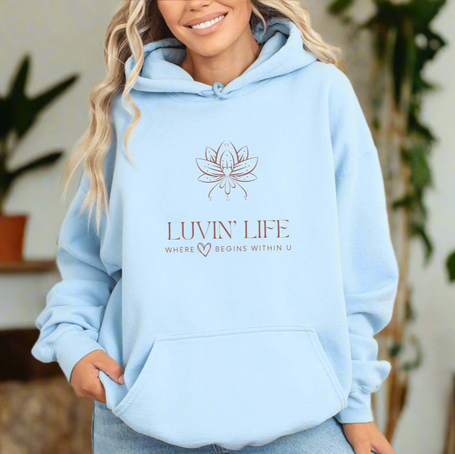 a woman wearing a light blue hoodie that says livvin life