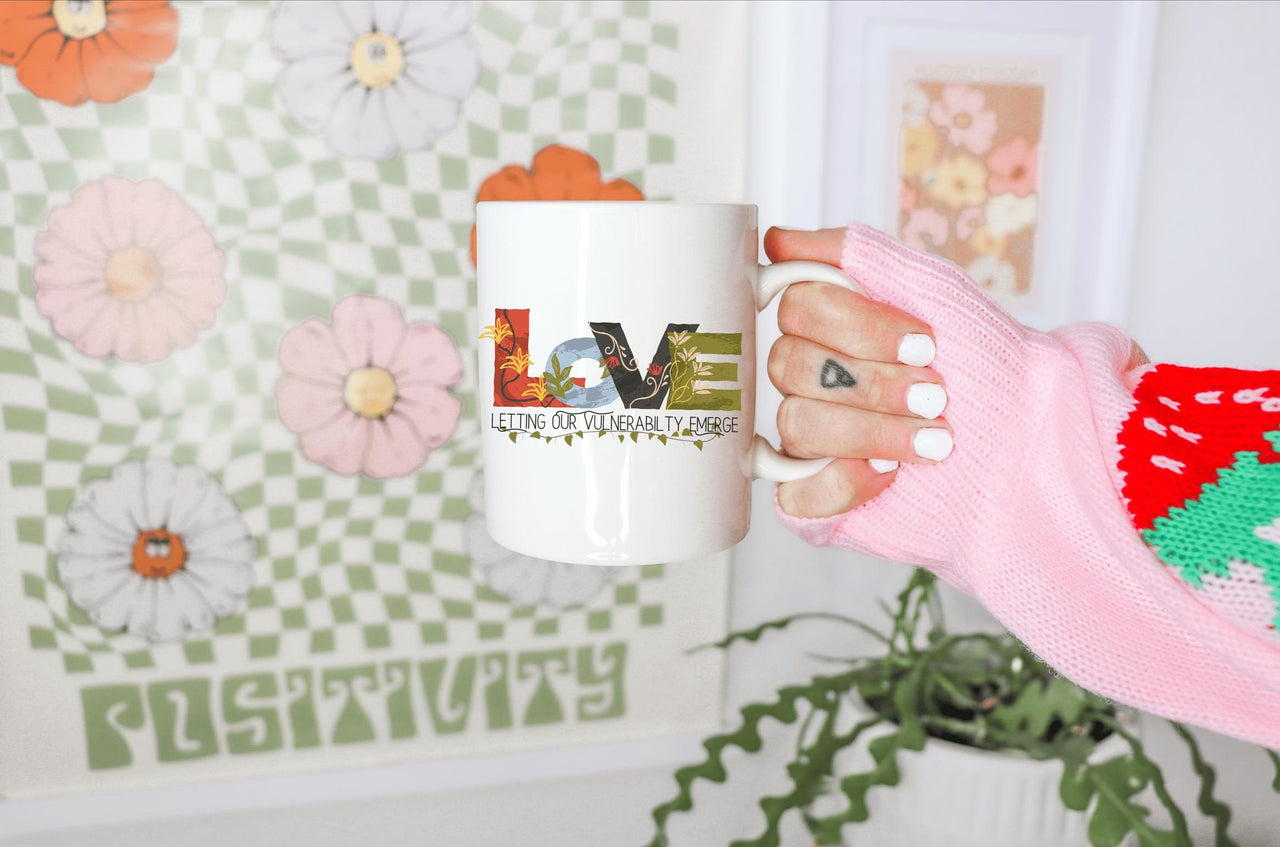 a person holding a coffee mug in their hand