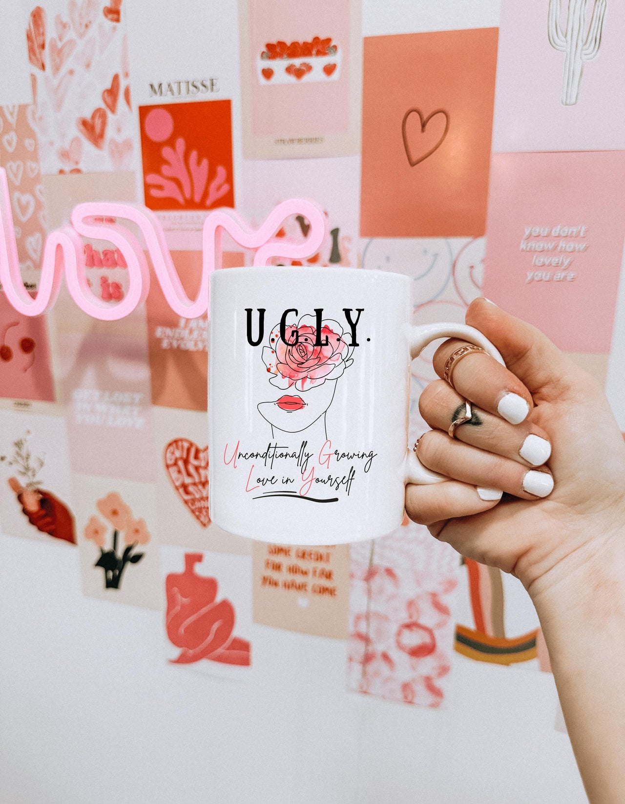 a person holding a coffee mug in their hand