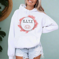 Thumbnail for a woman wearing a white hoodie with the words hate on it