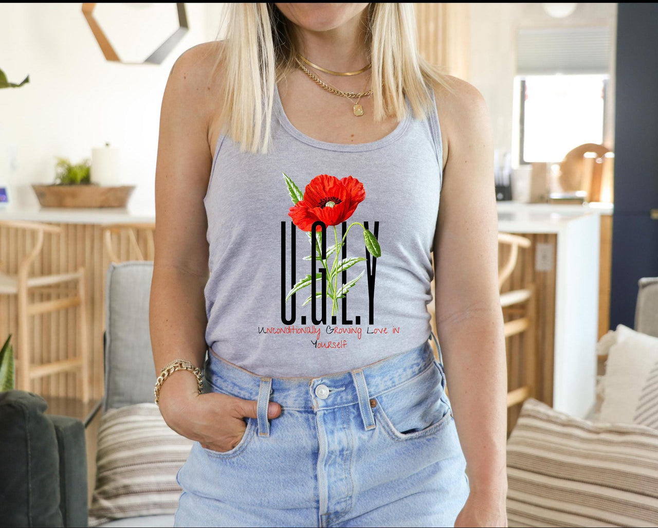a woman wearing a tank top with a flower on it