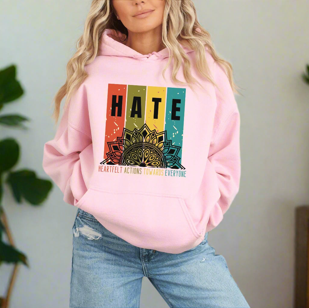 a woman wearing a pink hoodie with the words hate on it