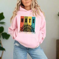 Thumbnail for a woman wearing a pink hoodie with the words hate on it