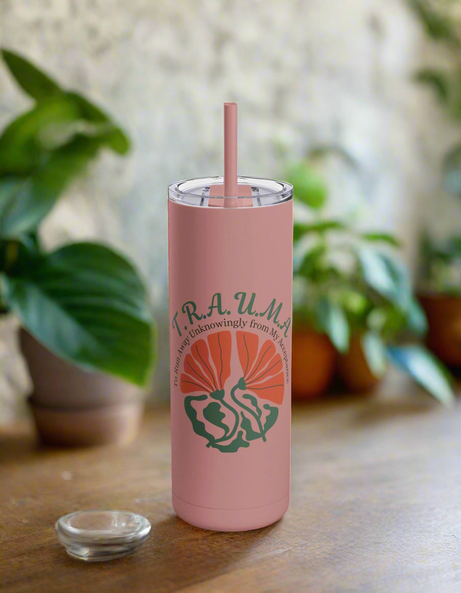 a pink tumbler cup with a straw in it