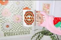 Thumbnail for a woman holding a coffee mug with the word heal on it