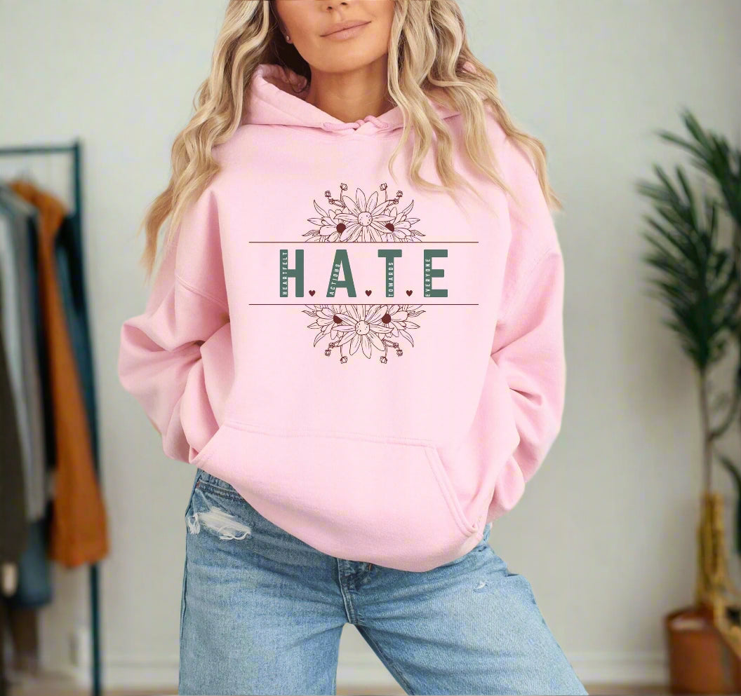 a woman wearing a pink hoodie that says hate