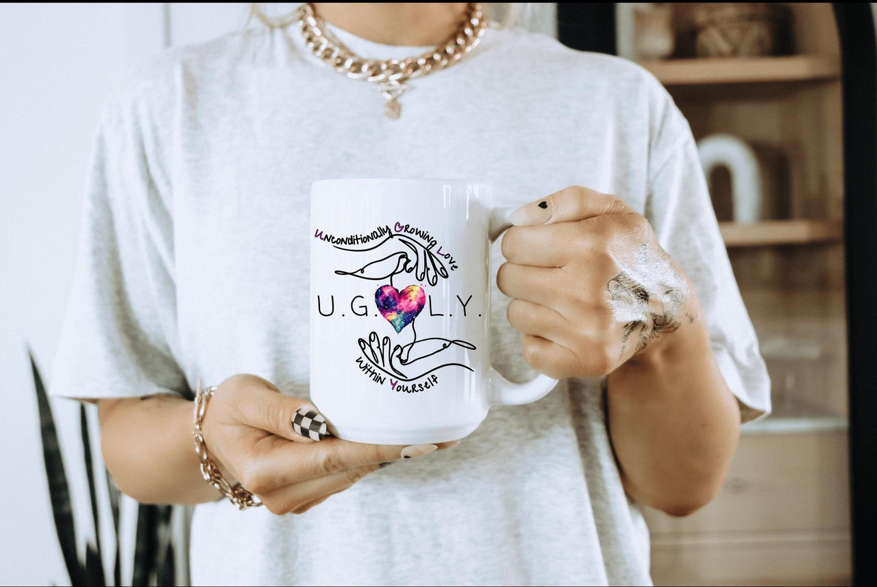 a woman holding a coffee mug with a heart on it