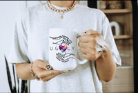 Thumbnail for a woman holding a coffee mug with a heart on it