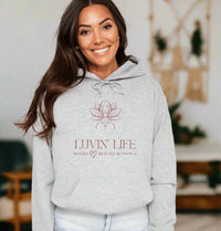 Thumbnail for a woman wearing a grey hoodie with the luvin'life logo on it