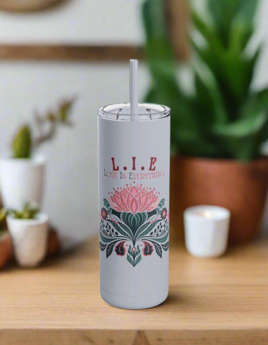 a white tumbler with a pink flower on it