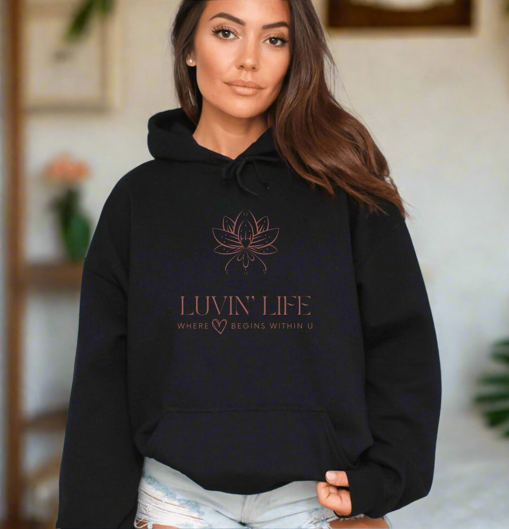 a woman wearing a black hoodie with the luvin life logo on it
