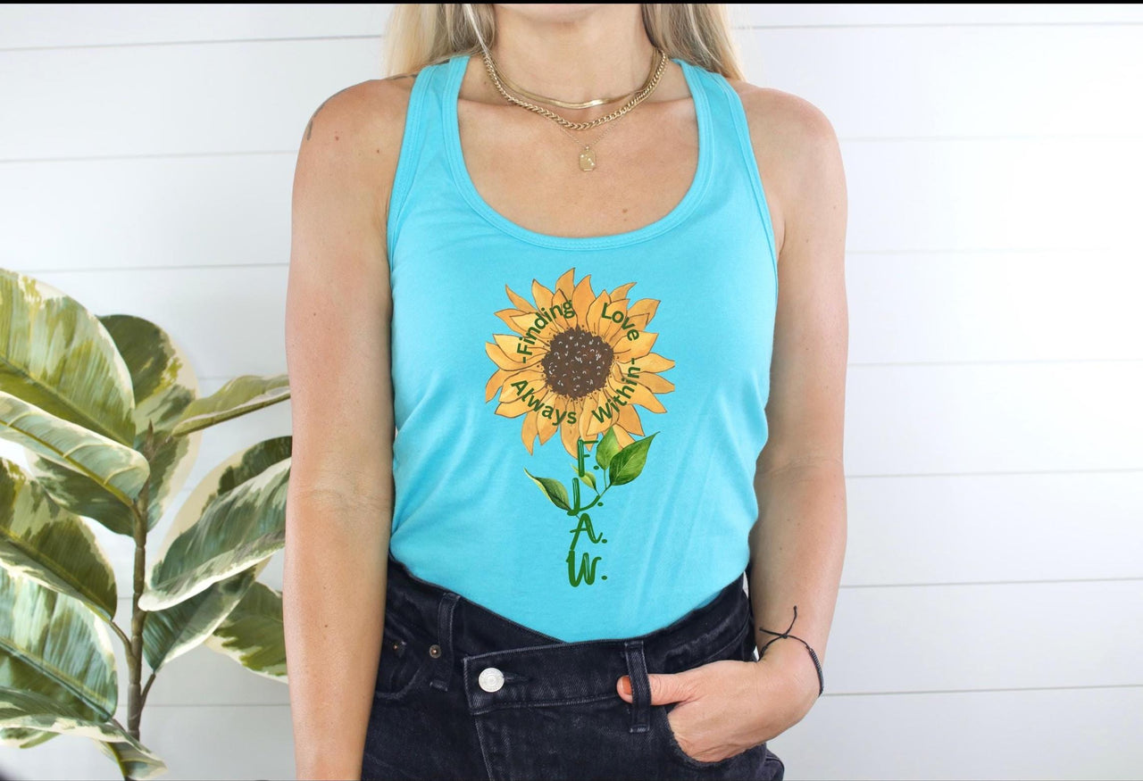 a woman wearing a blue tank top with a sunflower on it