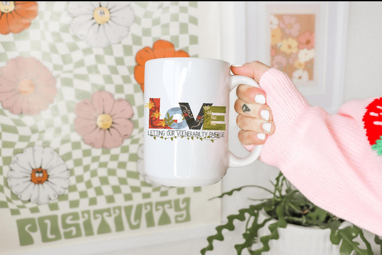 a person holding a coffee mug in their hand