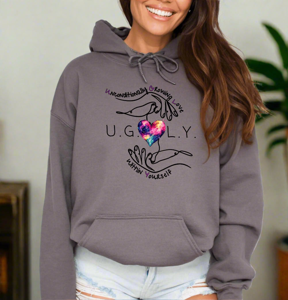 a woman wearing a grey hoodie with a heart on it