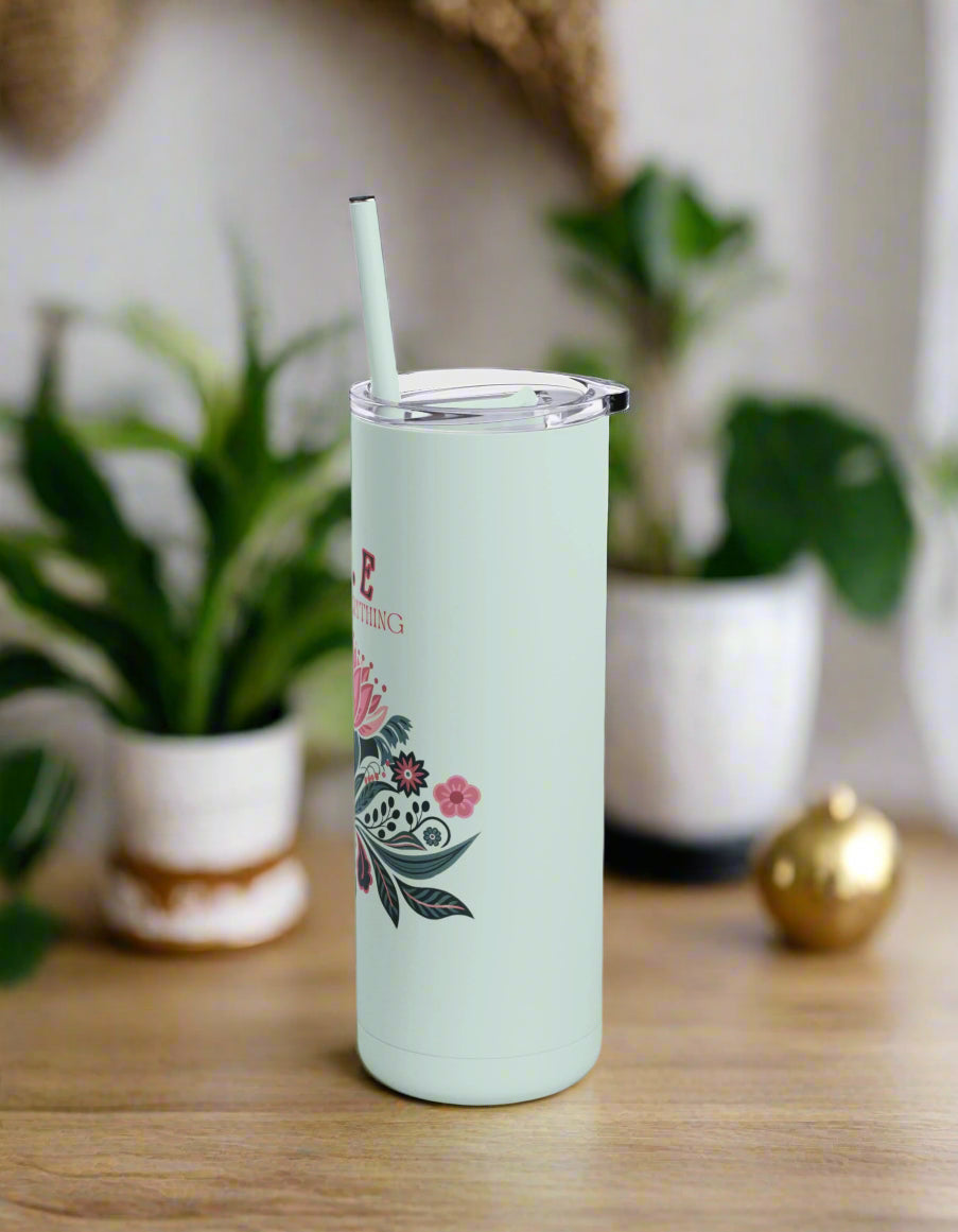 a tumbler cup with a straw sticking out of it