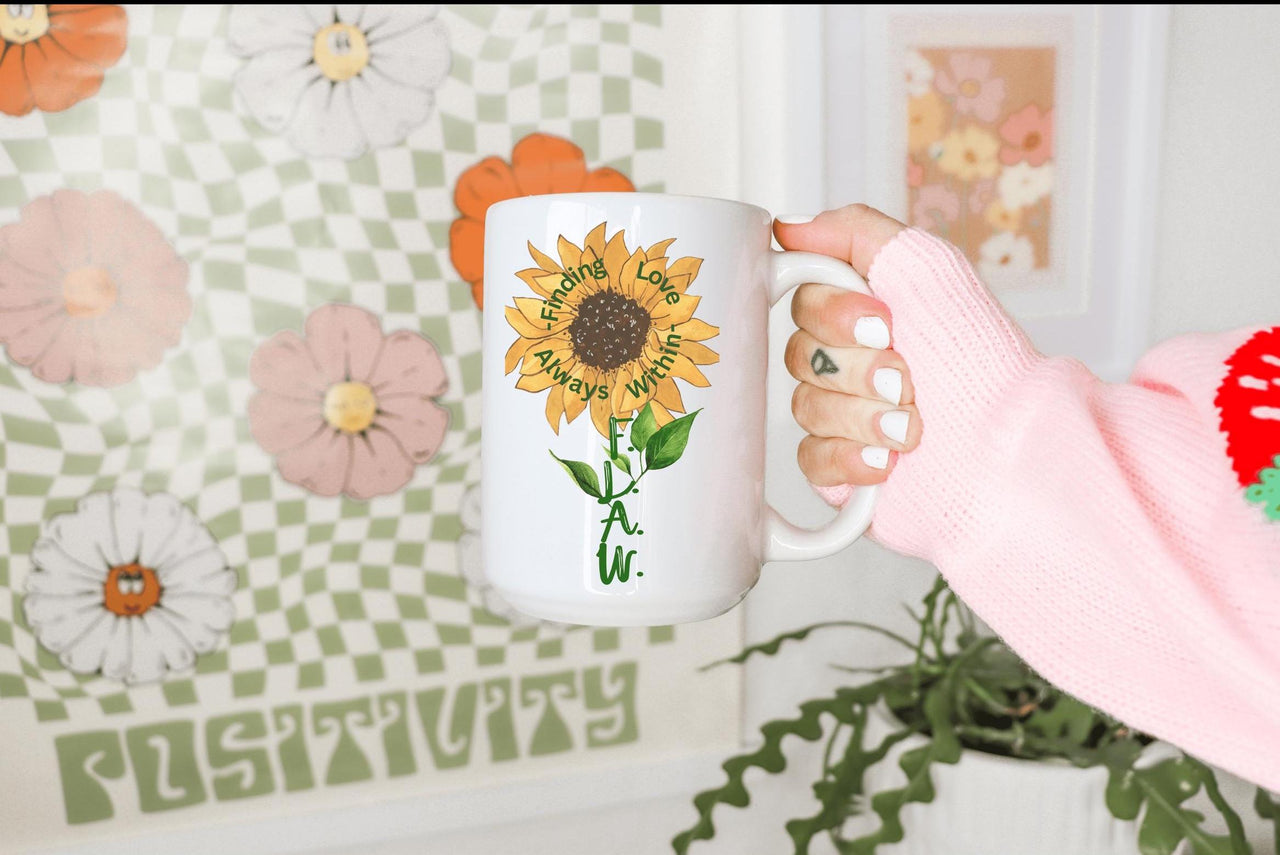 a woman is holding a coffee mug with a sunflower on it