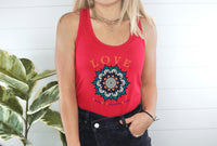 Thumbnail for a woman standing next to a plant wearing a red tank top