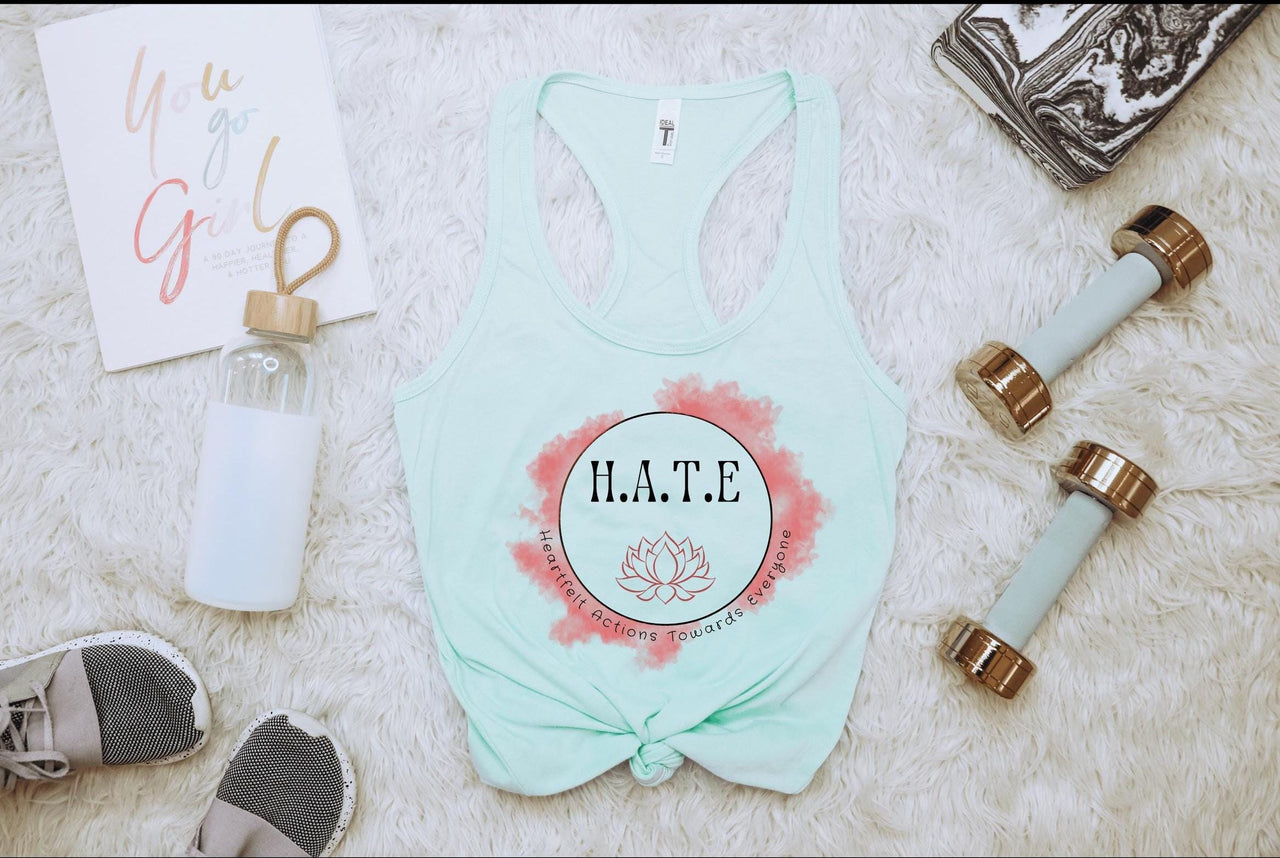 the contents of a women's tank top laid out on a bed
