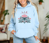 Thumbnail for a woman wearing a light blue hoodie with a flower design