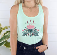 Thumbnail for a woman wearing a green tank top with a pink flower on it
