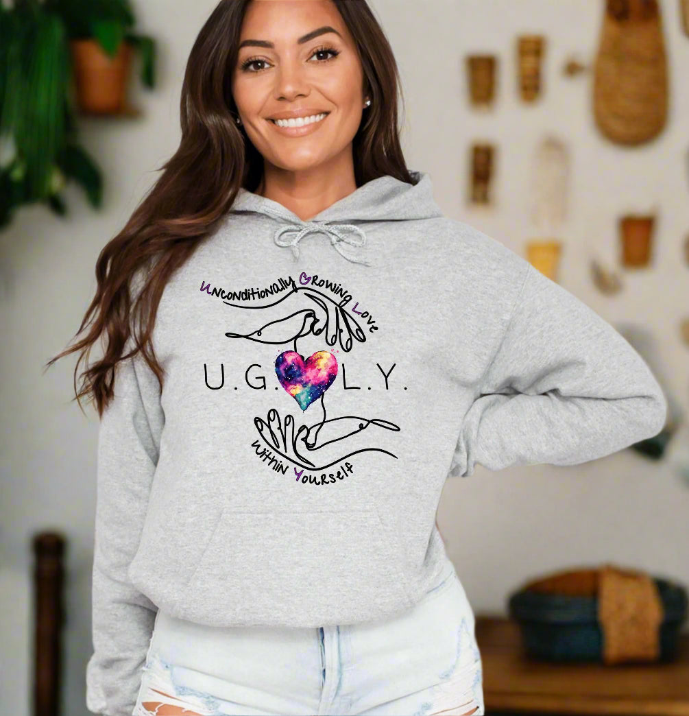 a woman wearing a grey hoodie with a heart on it