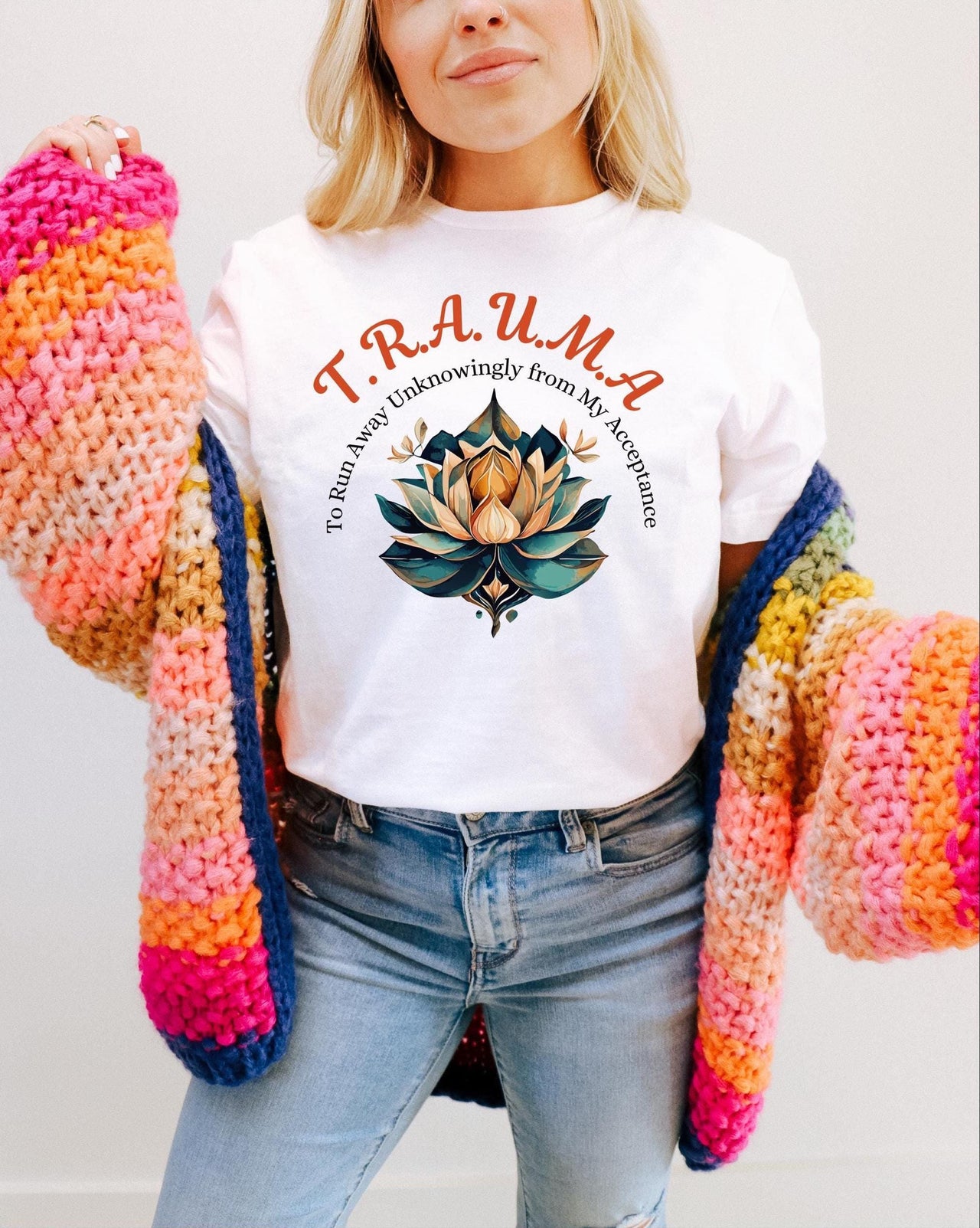 a woman wearing a white t - shirt and colorful knitted gloves