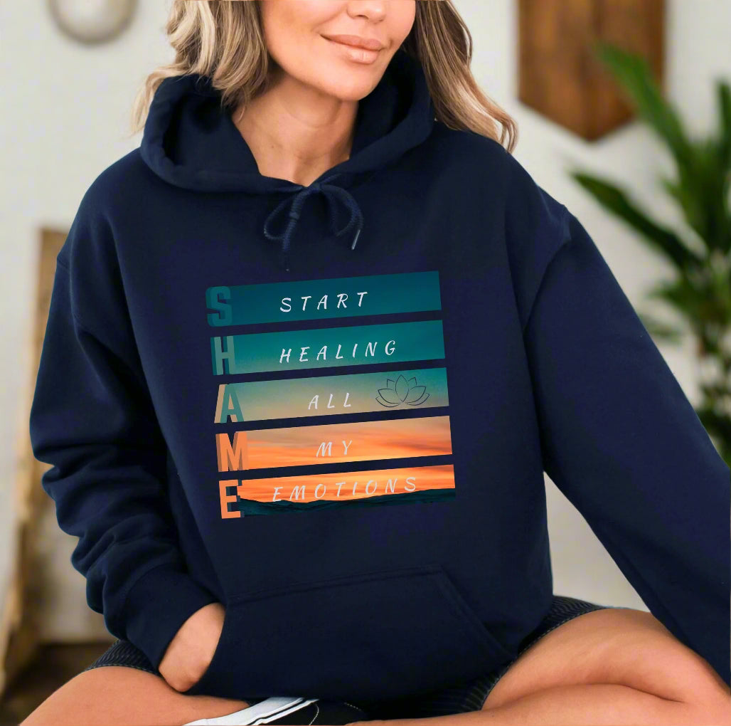 a woman sitting on the ground wearing a hoodie