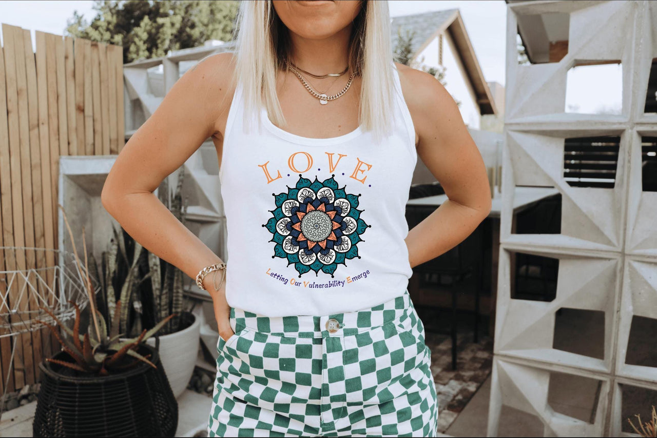 a woman wearing a white tank top and green checkered shorts