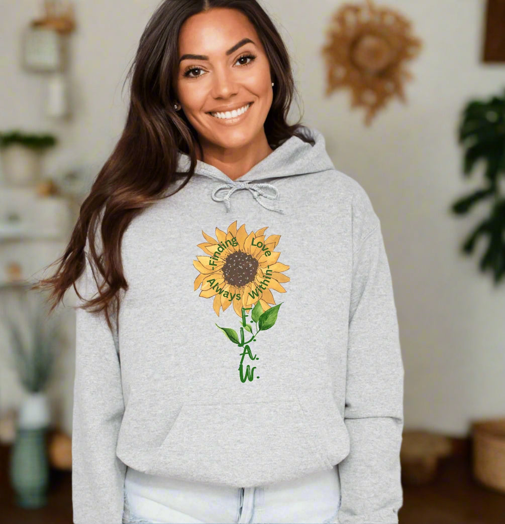 a smiling woman wearing a sunflower hoodie
