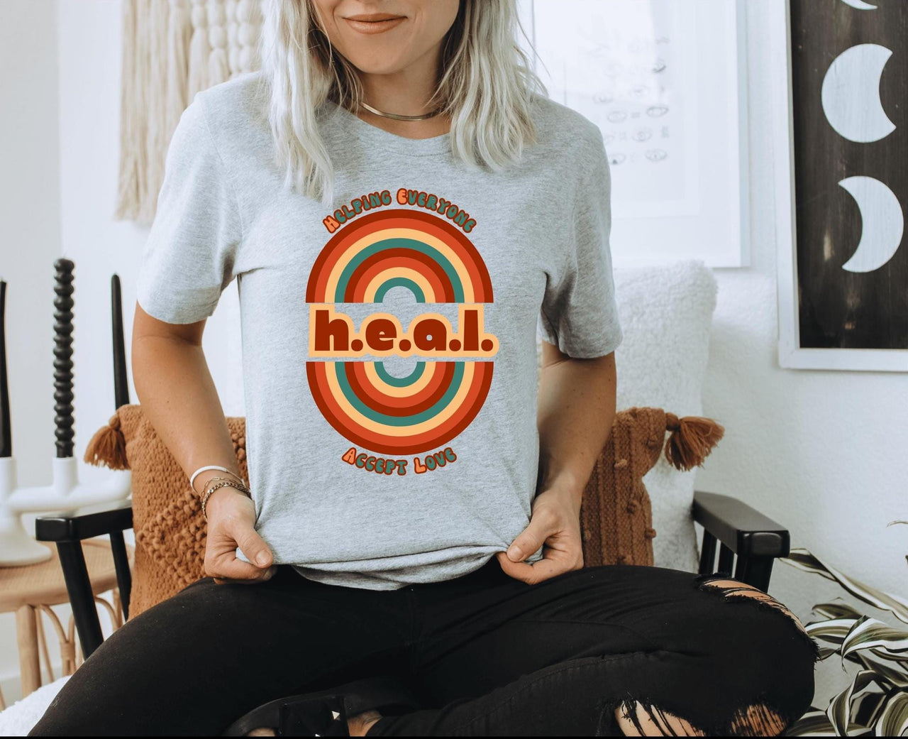 a woman sitting in a chair with a t - shirt on