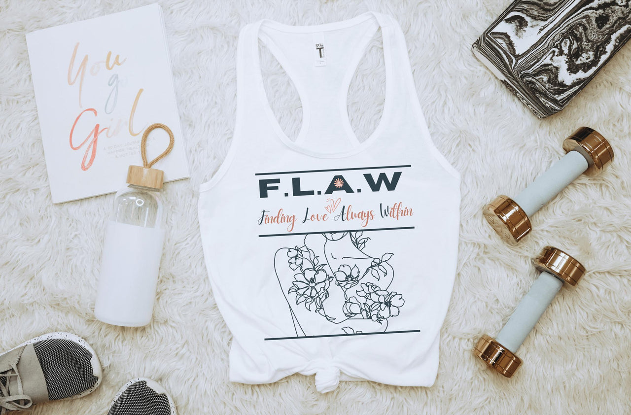 a woman's white tank top with flowers and a pair of scissors
