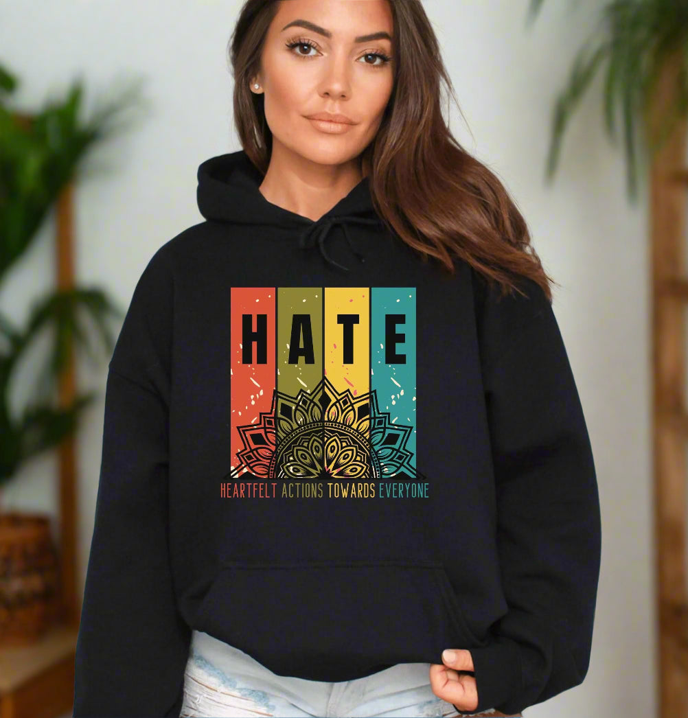 a woman wearing a black hoodie with the words hate on it