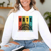 Thumbnail for a woman wearing a white hoodie with the words hate on it