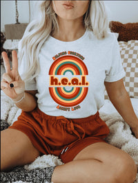 Thumbnail for a woman sitting on a bed holding a peace sign