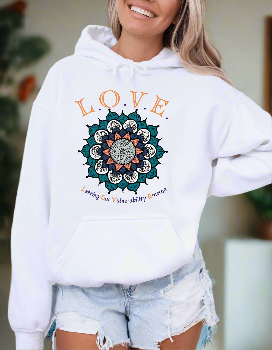 a woman wearing a white hoodie with the words love on it