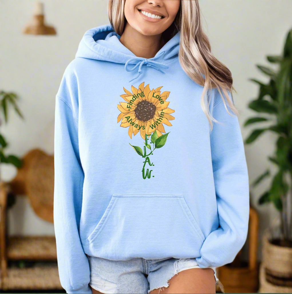 a woman wearing a blue hoodie with a sunflower on it