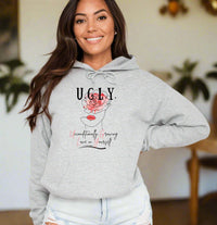 Thumbnail for a woman wearing a grey hoodie with the words ugly on it