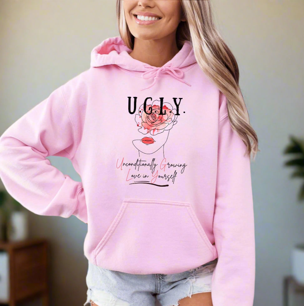 a woman wearing a pink hoodie with the words ugly on it
