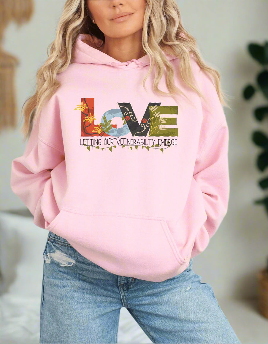 a woman wearing a pink hoodie with the words love on it