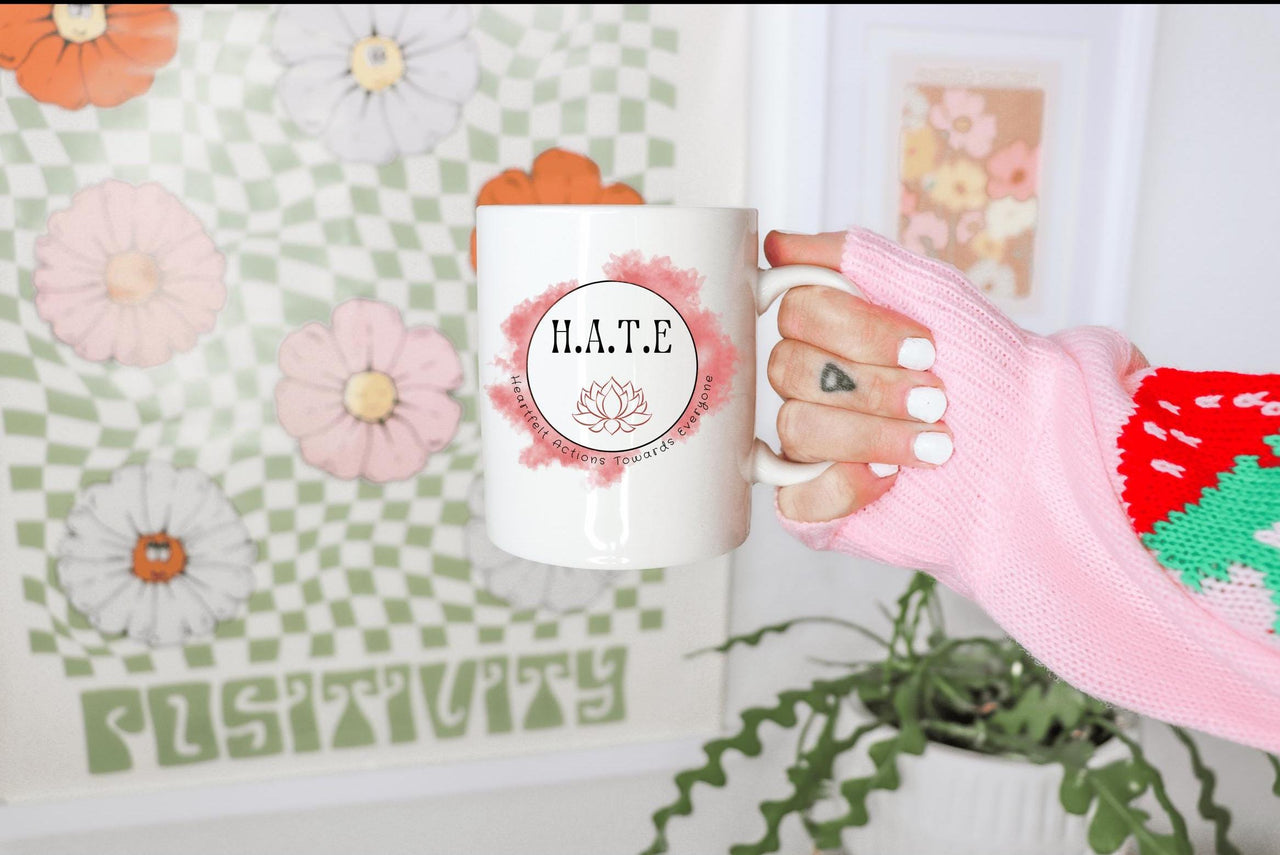 a person holding a coffee mug in their hand