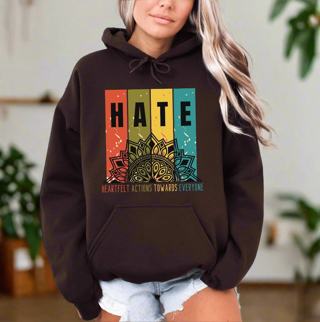 a woman wearing a brown hoodie with the words hate on it