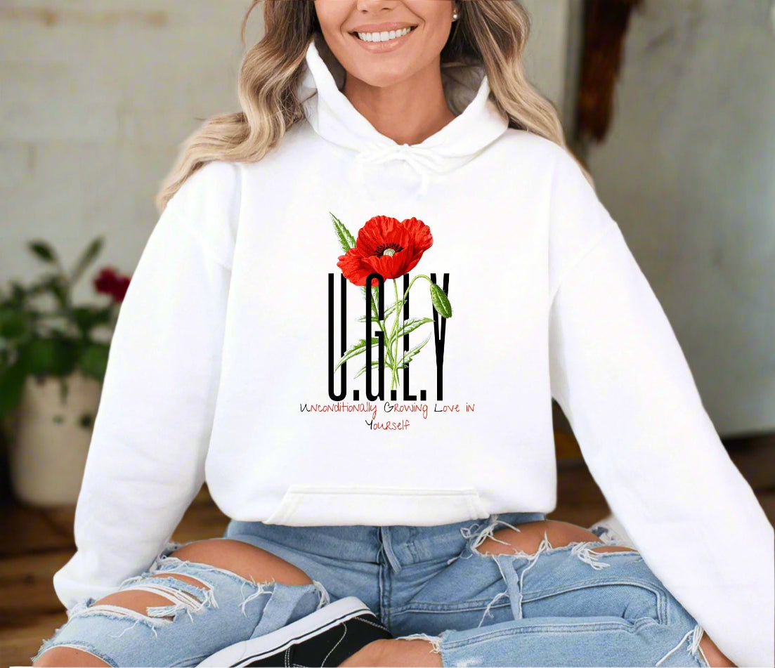 a woman wearing a white hoodie with a red flower on it