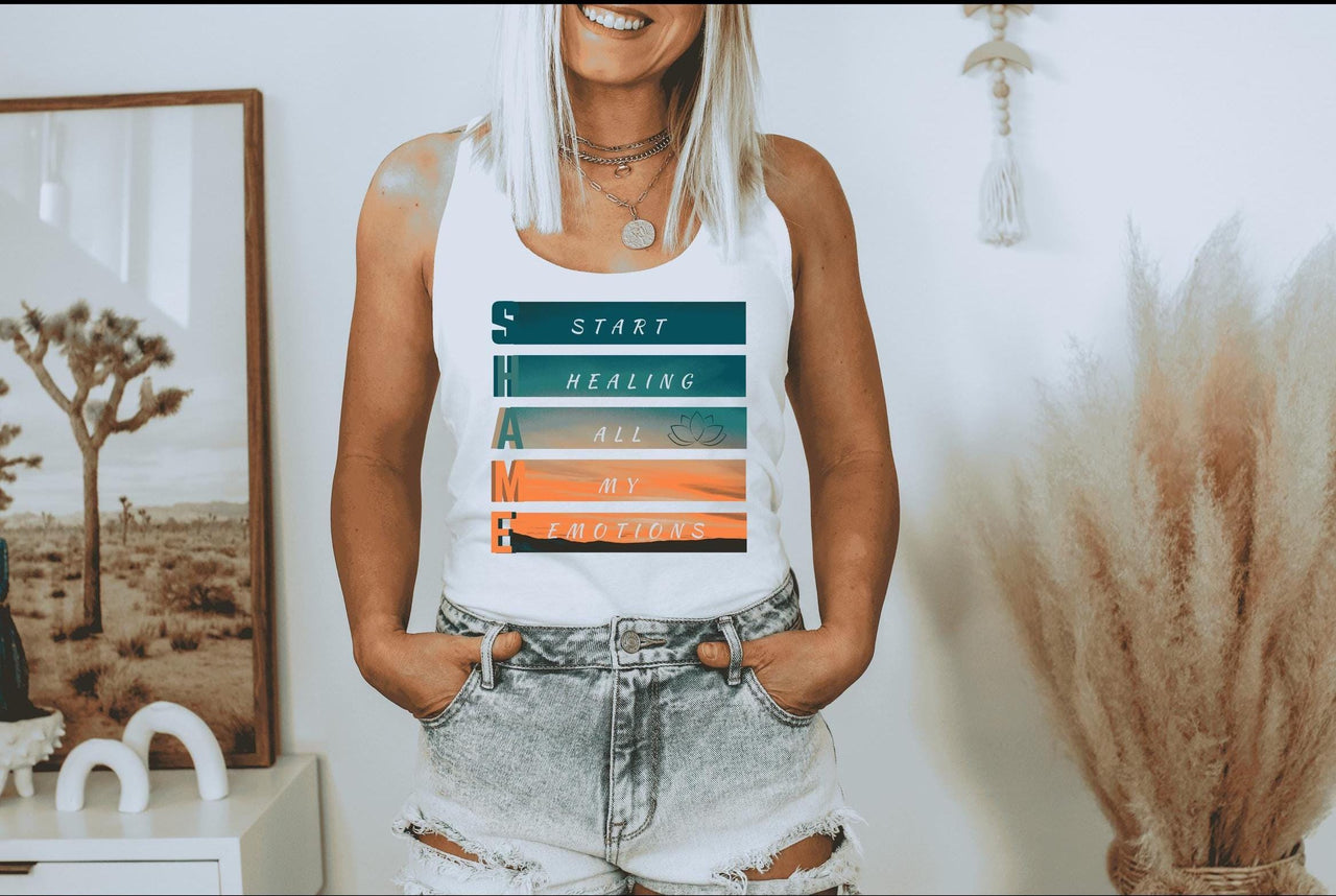 a woman in a white tank top is holding her hands in her pockets