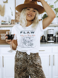 Thumbnail for a woman in a hat holding a glass of wine