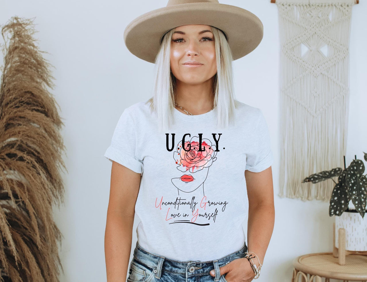 a woman wearing a white t - shirt with the words ugly on it